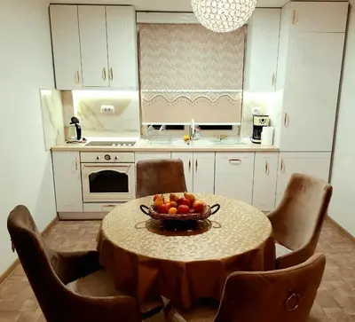 a kitchen with a table with a bowl of fruit on it at Lux Apartment ll Prijedor in Prijedor