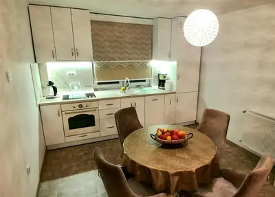 a kitchen with a table with a bowl of fruit on it at Lux Apartment ll Prijedor in Prijedor