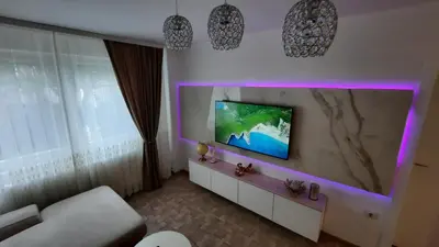 a living room with a flat screen tv on a wall at Lux Apartment ll Prijedor in Prijedor