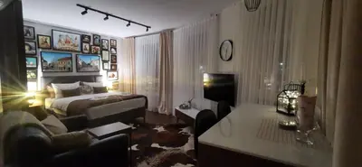 a bedroom with a bed and a living room at Tuzla Trg - Tuzla Square in Tuzla