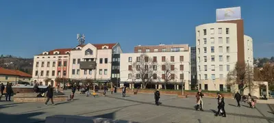 a group of people walking around a plaza in a city at Tuzla Trg - Tuzla Square in Tuzla