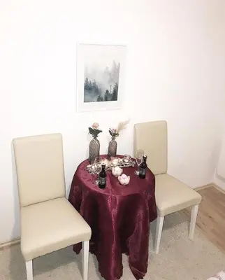 two chairs and a table with a purple table cloth at Apartman Dunja in Prijedor