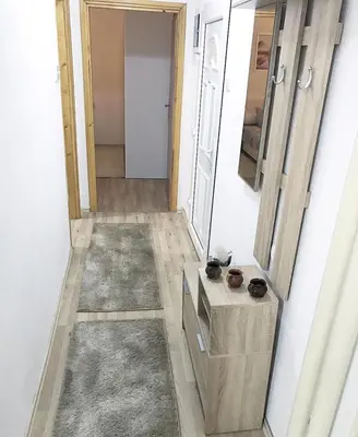a room with a hallway with a door and a mirror at Apartman Dunja in Prijedor