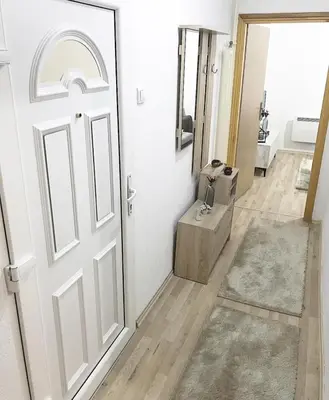 a white door in a room with a hallway at Apartman Dunja in Prijedor