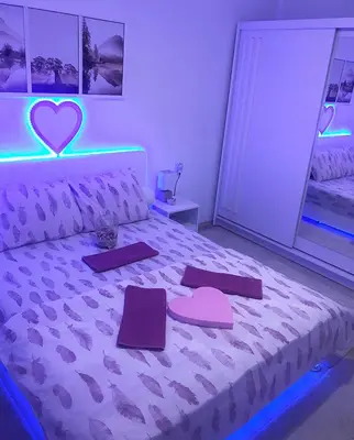 a bedroom with a bed with a heart on it at Apartman Dunja in Prijedor