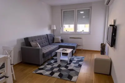 a living room with a couch and a table at S&S Apartman Banja Luka in Banja Luka