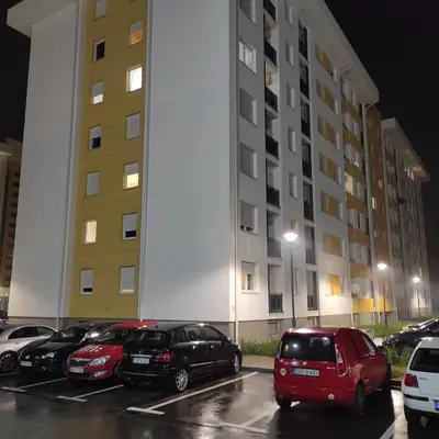 a group of cars parked in a parking lot in front of a building at S&S Apartman Banja Luka in Banja Luka