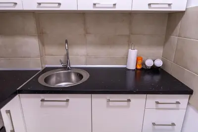 a kitchen with a sink and a counter top at S&S Apartman Banja Luka in Banja Luka