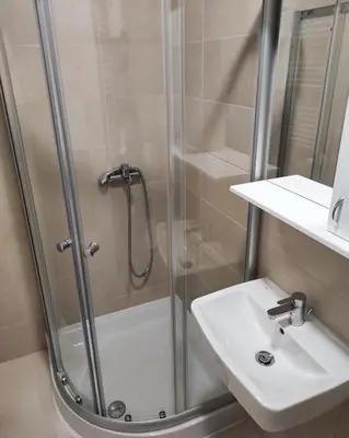 a bathroom with a shower and a sink at S&S Apartman Banja Luka in Banja Luka