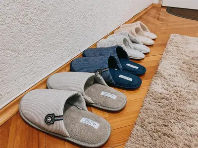 a group of pairs of shoes on a wooden floor at Take it easy Apartment in Visoko