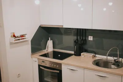 a small kitchen with a sink and a stove at Take it easy Apartment in Visoko