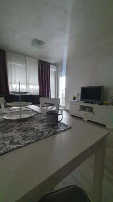 a living room with a couch and a tv at Apartman Basic 2 in Doboj