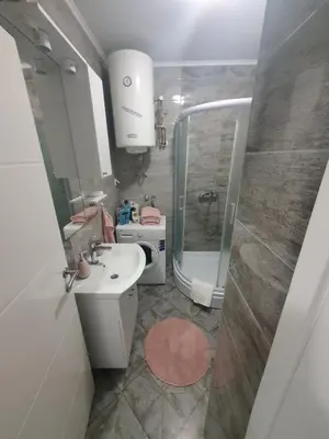 a small bathroom with a sink and a shower at Apartman Basic 2 in Doboj
