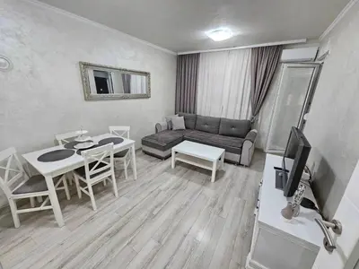 a living room with a couch and a table at Apartman Basic 2 in Doboj
