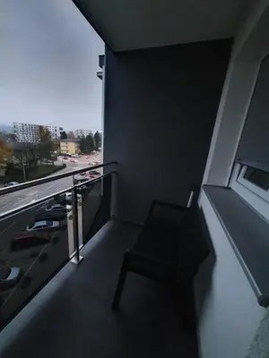a balcony of a building with a chair and a window at Apartman Basic 2 in Doboj