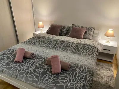 a bedroom with a large bed with two pillows on it at Iskra in Banja Luka