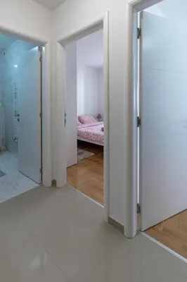 a room with two sliding doors and a bedroom at Iskra in Banja Luka