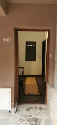 a view of a hallway with a mirror in a house at Apartman ALTA in Vlasic