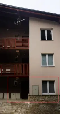 a building with a balcony on the side of it at Apartman ALTA in Vlasic