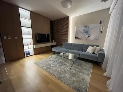a living room with a blue couch and a television at Exclusive BL apartments in Banja Luka