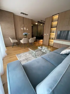 a living room with a blue couch and a table at Exclusive BL apartments in Banja Luka