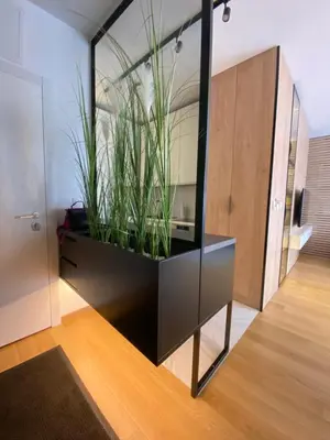 a black cabinet with plants in it in a room at Exclusive BL apartments in Banja Luka