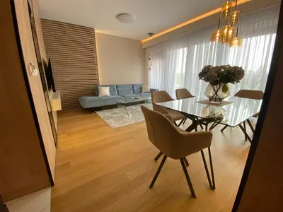 a living room with a glass table and a couch at Exclusive BL apartments in Banja Luka