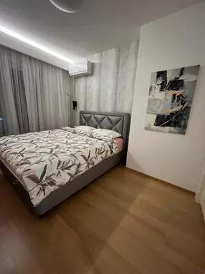 a bedroom with a bed and a painting on the wall at Exclusive BL apartments in Banja Luka
