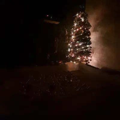 a christmas tree is lit up in the dark at Apartman Teddy12-Vlašić in Vlasic