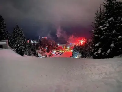 a ski resort with a fire at night in the snow at Apartman Teddy12-Vlašić in Vlasic
