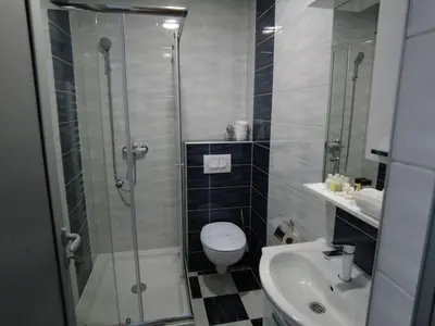 a bathroom with a shower and a toilet and a sink at MOTEL ALADIN in Cazin