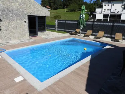 a blue swimming pool with a yellow ball in the water at MOTEL ALADIN in Cazin