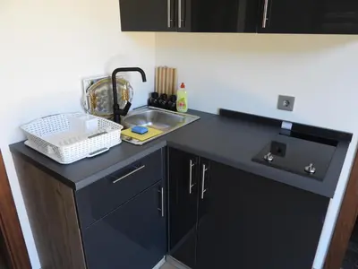 a small kitchen with a sink and a counter at MOTEL ALADIN in Cazin