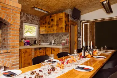 a long wooden table in a kitchen with a dining room at Srce Kozare in Prijedor