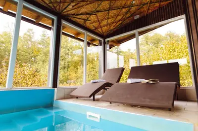 a room with two chairs and a swimming pool at Srce Kozare in Prijedor