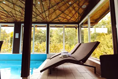 a hammock sitting on a porch next to a pool at Srce Kozare in Prijedor