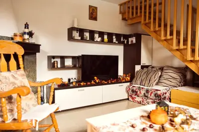 a living room with a couch and a fireplace at Srce Kozare in Prijedor