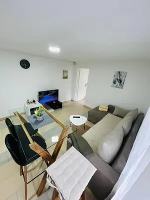 a living room with a couch and a table at Apartmani Star in Tuzla