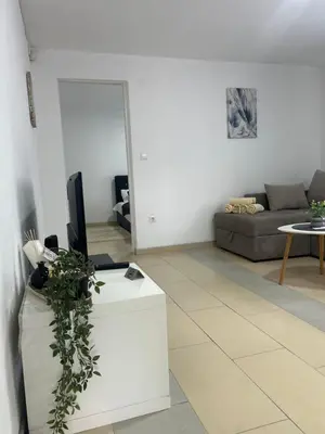 a living room with a couch and a television at Apartmani Star in Tuzla