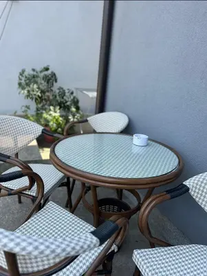 a table and chairs on a balcony with a coffee cup at Apartmani Star in Tuzla