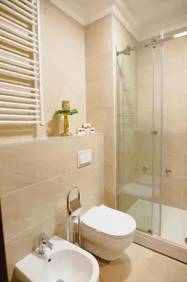 a bathroom with a toilet and a shower and a sink at Hotel Integra Banja Luka in Banja Luka