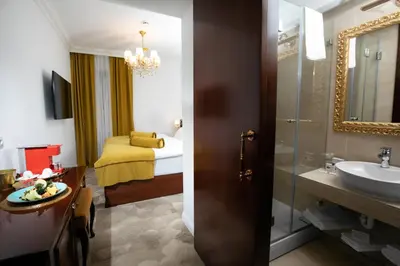 a bathroom with a sink and a bathroom with a bed at Hotel Integra Banja Luka in Banja Luka