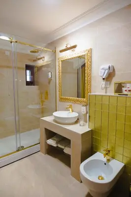 a bathroom with a sink and a toilet and a shower at Hotel Integra Banja Luka in Banja Luka