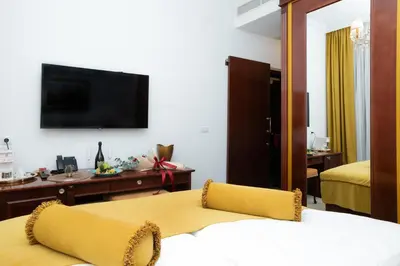 a hotel room with a bed and a flat screen tv at Hotel Integra Banja Luka in Banja Luka
