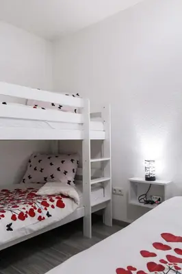 a bedroom with two bunk beds and a lamp at Villa Noa Kupres in Kupres