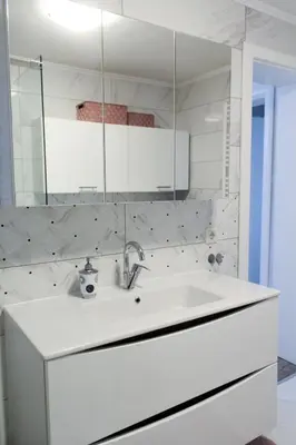 a white bathroom with a sink and a mirror at Villa Noa Kupres in Kupres