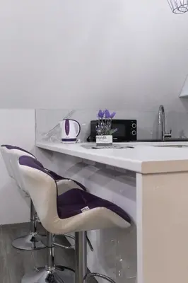 a white counter with two chairs and a sink at Villa Noa Kupres in Kupres