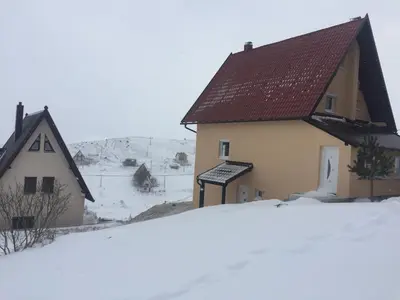 a house with snow in front of it at Villa Noa Kupres in Kupres