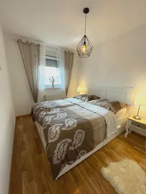 a bedroom with a large bed and a window at Orhidea Doboj in Doboj