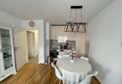 a kitchen and dining room with a table and chairs at Orhidea Doboj in Doboj